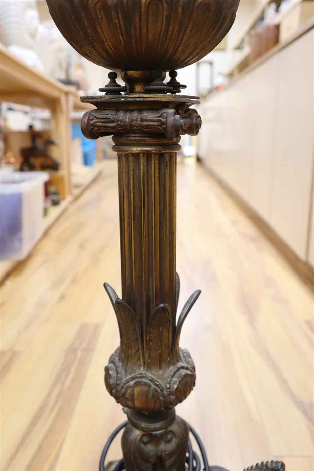 A 19th century gilt bronze and brass oil lamp on tri-form dragon supports (converted for electricity)